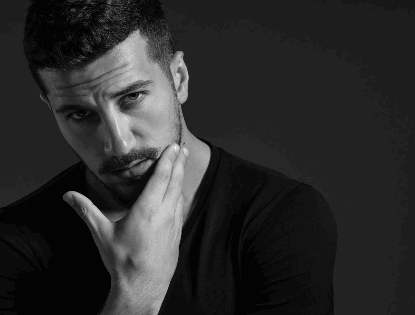 Pensive man touching his face